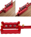 Dead On Precision Complete Self Centering Doweling Jig Kit With Professional Drill Bushes viewed from top with gray drill bushes on red aluminum base.