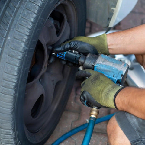 Mechanic using 14 Piece 1/2 Inch Drive Impact Socket Set With 10-24mm Deep Sockets on car wheel