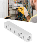 Pneumatic Manifold Air Distribution Block Made From Aluminum Alloy for Air Compressors, against electrical panel background