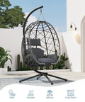 Outdoor Hanging Egg Chair With Stand Wicker Rattan Swing Chair With Cushioned Comfort on patio, white wall backdrop