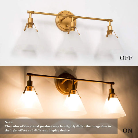 Three Light Gold Vanity Light Fixtures With White Frosted Glass Shades Over Mirror In Brushed Antique Gold Finish, on and off view