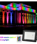 JUDYSSY RGB Led Floodlight Reflector Outdoor Lighting Ac 220 50W illuminated a building in vibrant colors at night.
