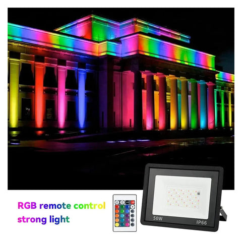 JUDYSSY RGB Led Floodlight Reflector Outdoor Lighting Ac 220 50W illuminated a building in vibrant colors at night.