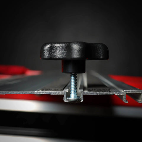 Side view of 5/16 Inch Threaded Knob Kit With Bolts And Washers in T-track system on a red surface, showing knob and bolt inserted.