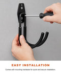 Installing Heavy Duty Steel EV Charger Bracket Wall Mount Garage Cable Organizer with a screwdriver for secure setup.