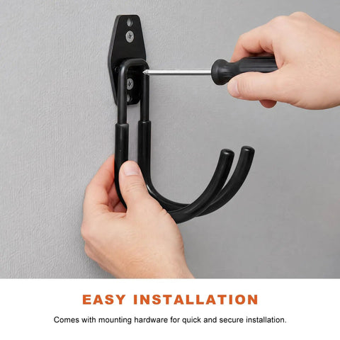 Installing Heavy Duty Steel EV Charger Bracket Wall Mount Garage Cable Organizer with a screwdriver for secure setup.
