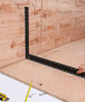 Carpenter Framing L Shape Square 16 Inch By 24 Inch Steel with white on black markings used on wood surface.