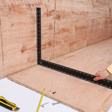 Carpenter Framing L Shape Square 16 Inch By 24 Inch Steel with white on black markings used on wood surface.