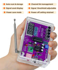 Hand holding FM Radio Kit For Beginners With Soldering Practice And Electronics Learning Project Including PCB Components Speaker And Case Build A Real Radio From Scratch And Learn Basic Circuit Design Hands On STEM Education displaying PCB with digital screen and antenna