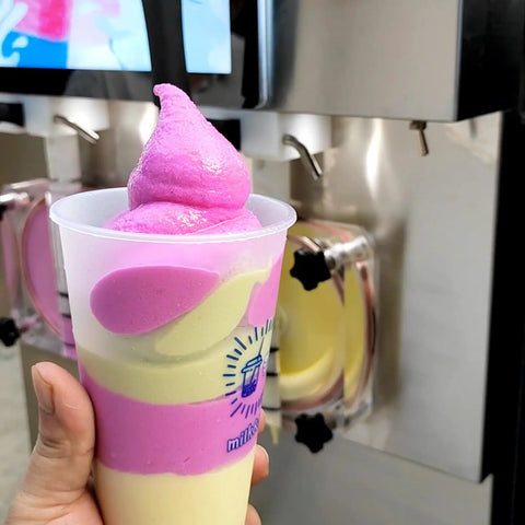 Commercial Dual Tank Ice Slush Machine For Top Shelf Margaritas And Creamy Milkshakes With Smart Freeze Tech and Heavy Duty Build showcased with a swirled drink.