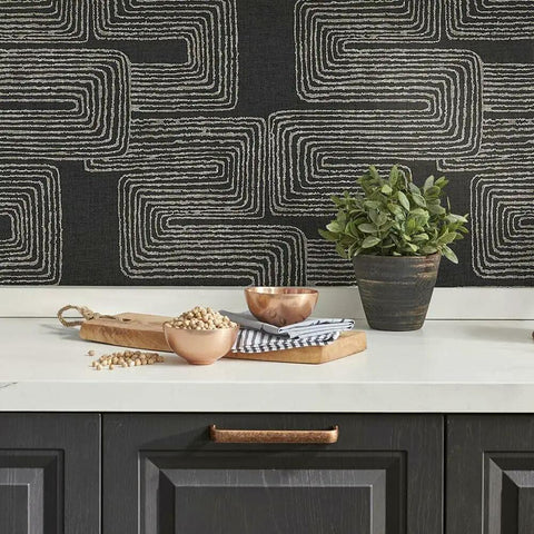 Kitchen with Nikki Chu Black And White Zulu Signature Peel And Stick Wallpaper Roll and modern decor elements on counter.
