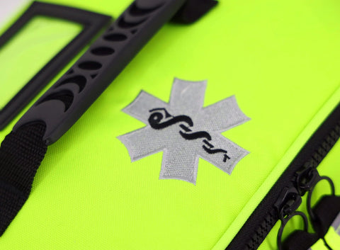 EMT first responder bag in fluorescent yellow with star of life patch; close-up of black zipper and strap.