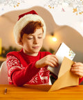 Child in festive sweater holding a floral note card from 100 Piece Floral Blank Note Cards Set, 4 by 6 Inches, Bulk Notecards.