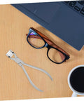 Stainless Steel Eyeglasses Frame Bending Pliers Pro Grade Gear Optical Repair Tool on desk with eyeglasses and laptop