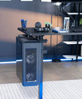 Hella Sturdy Clamp On Desk Leg Mount For Large PC Towers Under Desk CPU Storage Rack Easy Tool Free Setup Keeps Your Rig Off The Floor Gamer Battlestation Desk Organizer Black attached to a modern desk with a large PC tower.