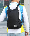 Person wearing Ultra Lightweight Daypack Water Backpack For Camping, Hiking, Climbing And Riding Foldable Easy Carry Pack