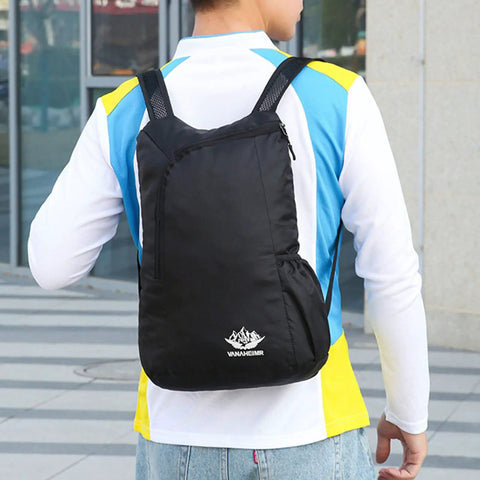 Person wearing Ultra Lightweight Daypack Water Backpack For Camping, Hiking, Climbing And Riding Foldable Easy Carry Pack