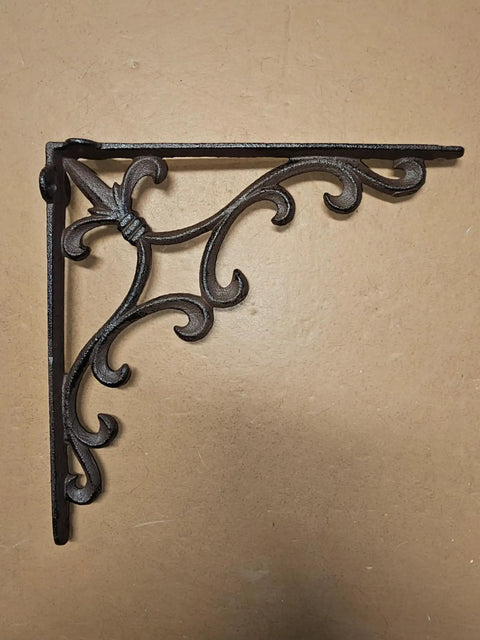 Sturdy Cast Iron Shelf Bracket Set 10 By 10 Inches, Ornate Fleur De Lis Design, matte brown finish, shown on a beige background.