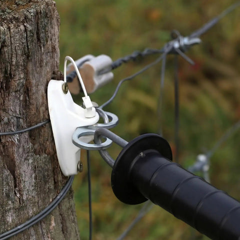 Close-up of 10 Piece T Post Gate Hook Set For Electric Fence High Tensile Ranch Farm And Property Heavy Duty Eyelet Insulator on wood post