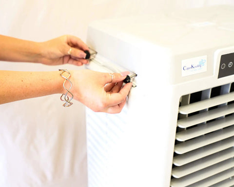 Hands adjusting the controls of a Heavy Duty Portable Evaporative Swamp Cooler With 3000 CFM Blower And Ten Gallon Ice Ready Tank.
