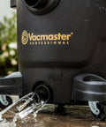 Close-up of Beast Series 16 Gallon Wet/Dry Shop Vac With 6.5 HP Motor base draining water, showcasing durable wheels.