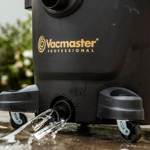 Close-up of Beast Series 16 Gallon Wet/Dry Shop Vac With 6.5 HP Motor base draining water, showcasing durable wheels.