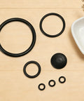 Seal Gasket Set For 20000 Sprayers Replacement Parts Kit Includes Six Seals Across Four Sizes And One Rubber Base Pad Easy To Install Durable Sprayer Maintenance. Black rubber gasket rings and base pad for sprayer repair.