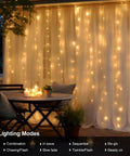 Battery Operated Fairy Curtain Lights With Remote Timer Nine Point Eight Feet By Nine Point Eight Feet Of Warm White LEDs illuminating patio