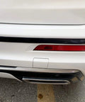 Installed glossy black 1/2-inch automotive trim molding along rear bumper on white car