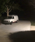 Driveway illuminated by WiFi Floodlight Bulb Camera For Outdoor Security, 1080P Night Vision, Waterproof Wireless CCTV System With Remote Control, Easy Install, 360 Degree Rotating Head, No Wires Needed.