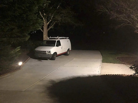 Driveway illuminated by WiFi Floodlight Bulb Camera For Outdoor Security, 1080P Night Vision, Waterproof Wireless CCTV System With Remote Control, Easy Install, 360 Degree Rotating Head, No Wires Needed.