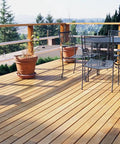 Wooden deck with potted plants and outdoor furniture; ideal for projects using PrimeGuard Plus Premium Deck Screws For Outdoor DIY Projects.