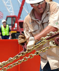 Worker securing load with Grade 70 Binder Chain With Clevis Grab Hooks, 3/8 Inch By 20 Foot, Heavy Duty Tie Down Chain on job site