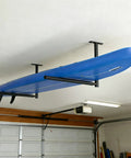 Stainless Steel Ceiling Storage Rack With 10 To 18 Inch Adjustable Height, Heavy Duty Overhead Garage Organizer That Hauls Up To 100 Lbs For Kayaks, Surfboards, Canoes, Skis, Ladders And More holding a blue surfboard