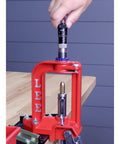 Dead Nuts Accurate Rifle Micrometer Adjustment Screw for Universal Bullet Seating Dies on a red press for precision reloading.