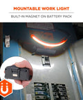 Hand holding Skullerz 8886 Wide Beam Headlamp with hard hat mount and power bank, shown mounted on a metal surface.