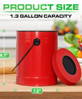 Red metal 1.3 gallon pail with lid for countertop use, shown on kitchen counter with vegetables in background.