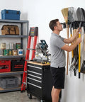 Man organizing tools on a heavy duty 48 inch garage tool organizer wall mount rack holds up to 350 lbs for shovels, rakes and power tools