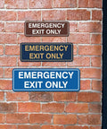 Emergency Exit Only Sign For Walls Or Doors Large Brushed Silver Durable Plastic Construction No Fuss Install With Mounting Tape Included Not Pre Attached Clear Readable Text For Quick Safety on brick wall