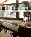 Person playing keyboard with 61 Key Note Sticker Guide Labels, showing color-coded notes for easy learning, in a bright room.