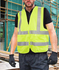 Top Shelf High Visibility Reflective Safety Vest, Fluorescent Neon Yellow, Heavy Duty Construction Work Gear With Roomy Pocket, Super Breathable Unisex Vest For Crews And Surveyors Daily worn by a man on a construction site.