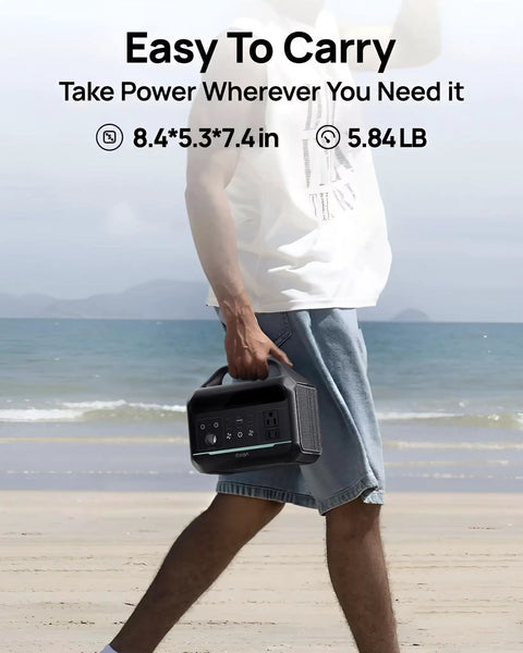 Man carrying Premium Portable Power Station 300W 192Wh LifePo4 Battery Backup at the beach, showcasing easy portability.