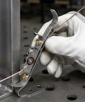 Ultimate TIG Wire Feeder Tool With Magnetic Base And Heat Shield For Alloy Filler Rods, close-up use for precise wire guiding.