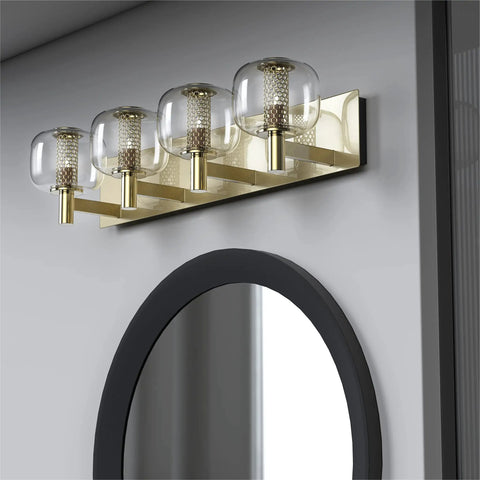 Vintage Brushed Brass Vanity Light with Clear Glass Globe Lampshades, 29 Inch 4 Light Bathroom Fixture on wall above mirror.
