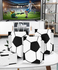 12 Pack Soccer Themed Party Favor Bags With Handles on a table in a room, TV with a soccer match in the background.