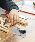 Precision Rugged Aluminum Fountain Scriber Line Tool For Construction And Woodworking Lightweight Ink Level Marker on wooden workbench with hand.