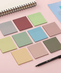 Colorful sticky notes with notebook and pen, not the Transparent Sticky Notes Set With 12 Pads And 600 Sheets See Through 3 By 3 Inch Self Adhesive Notes For Bible Journaling And Studying Water Resistant Easy To Peel And Clean Removal.