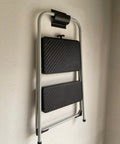 Side view of a ladder mounted using Heavy Duty Steel Wall Mount Ladder And Wheelbarrow Hanger Set, Matte Black, Pack Of 2 For Your Garage Organization