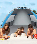 Family enjoying the X-Large 4 Person Beach Tent Sun Shelter Portable Instant Pop-Up Shade for the Beach, Fishing and Camping, Blue.