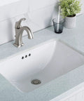 Elavo 21 Inch Rectangular Undermount White Porcelain Bathroom Sink With Overflow installed on a speckled countertop